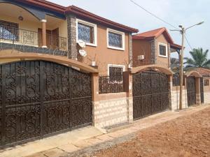 a house with a black gate and a driveway at KARIBU G&H Location Meublée Furnished Rental in Yaoundé