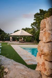 a swimming pool with a gazebo and a table at Villa Patrizia-Luxury Villa in Mottola