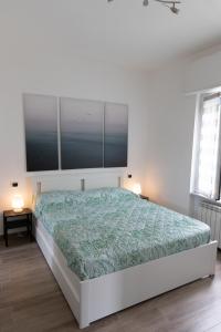 a bedroom with a bed with a large tv on the wall at Casa Pietro e Bea in Rapallo
