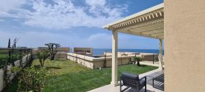 a house with a patio with a view of the ocean at Salt n Blue Villa Palase in Palasë