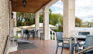 an outdoor patio with tables and chairs on a building at Hotel Castro in Santiago de Compostela