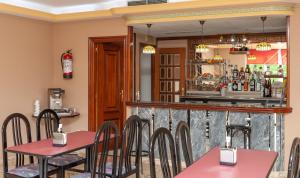 a restaurant with pink tables and a bar at Hotel Castro in Santiago de Compostela