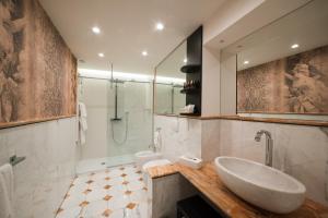 a bathroom with a sink and a shower at Royal Palace Hotel in Turin