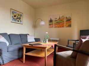 a living room with a couch and a table at das alte Wasserwerk in Bad Bentheim