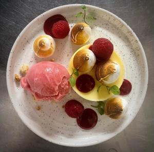 a plate of food with meat and strawberries on it at The Boarding House in Halesworth