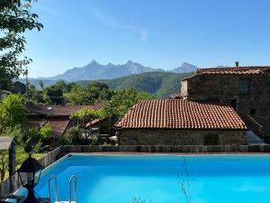 a swimming pool in front of a house with mountains at Agriturismo B&B Luna di Quarazzana in Fivizzano Tuscany in Fivizzano