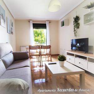 a living room with a couch and a table at RECUERDOS de ASTURIAS in Piedras Blancas