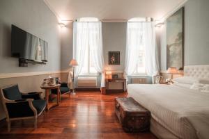 Postel nebo postele na pokoji v ubytování Royal Palace Hotel