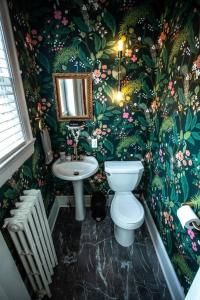 a bathroom with a toilet and a sink at Charming 1932 Craftsman - The Bohannon House in Luray