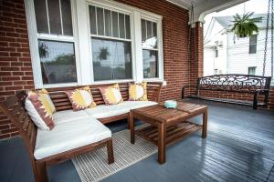 a porch with couches and a table and windows at Charming 1932 Craftsman - The Bohannon House in Luray