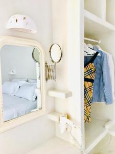 a bedroom with a mirror and a bed at Deluxe Studios & Suites Ageri-Milos in Adamantas +114 photos