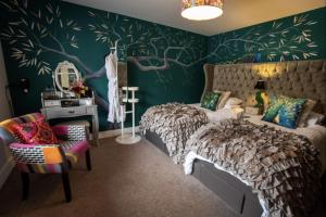 a bedroom with a bed and a green wall at Maes Bach Boutique GUEST HOUSE TOWN CENTRE in Aberystwyth