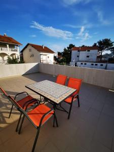 a table and chairs sitting on a roof at Apartman Smokva in Vodice
