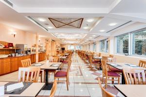 a row of tables and chairs in a restaurant at HOTEL VILLA MARIA in Cesenatico