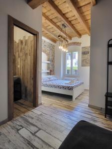 a bedroom with a bed and a wooden floor at L' Onda di Manarola in Manarola