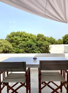 a table and two chairs on a patio at Dimora delle Tonnare in Favignana