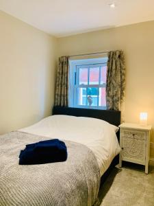 a bedroom with a bed and a window at The Beachfront Lookout a Stunning Apartment with Perfect Sea View in Worthing