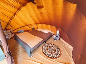 a bedroom with two beds in a dome tent at Camping La Tourelle in Plémy