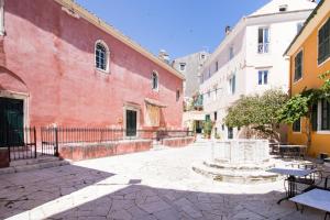 an alley in a city with a red building at Fontana Di Corfu 4 in Corfu Town