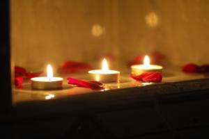 a group of candles sitting on a table with red flowers at Hôtel Riad Salam Agadir in Agadir
