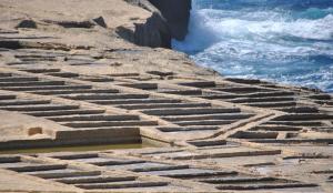 a stone labyrinth on the side of the ocean at The Segond Hotel in Xagħra