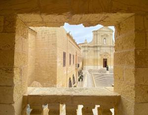 a view of a building from a stone window at The Segond Hotel in Xagħra