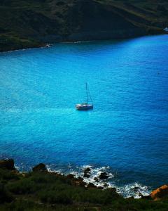 a boat in the middle of a large body of water at The Segond Hotel in Xagħra