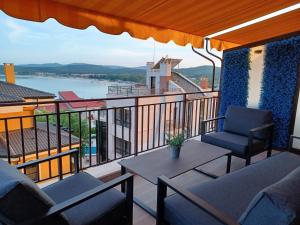 a balcony with two chairs and a table and a view at Apartments Provence in Sozopol