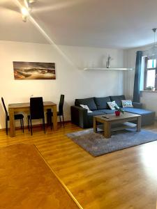 a living room with a couch and a table at Apartmány U Vodního hradu in Česká Lípa