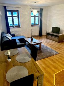 a living room with a couch and a table at Apartmány U Vodního hradu in Česká Lípa