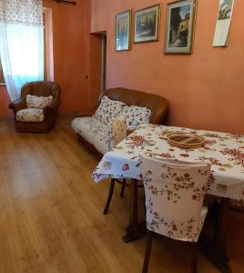 a living room with a table and a couch at Appartamento Giallo in Rio Marina