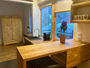 a kitchen with a wooden counter top and a window at Chata pod Rogową Apartamenty in Javorina