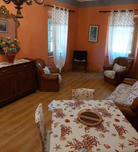 a living room with a table and a couch at Appartamento Giallo in Rio Marina
