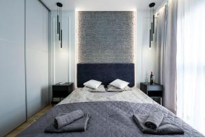 Posteľ alebo postele v izbe v ubytovaní Apartament Szafir