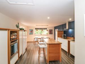 a kitchen with a table and chairs in a room at Holloway House in Wotton-under-Edge