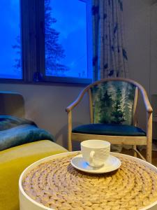 a table with a cup and a plate on a table at Chata pod Rogową Apartamenty in Javorina