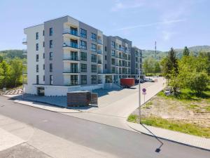 a large apartment building on the side of a street at Apartamenty Pod Szyndzielnią blisko kolejki i Hali Pod Dębowcem - Dream Apart in Bielsko-Biała