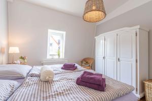 a bedroom with two beds with purple towels on them at Captains Haven in Eckernförde