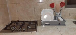 a kitchen counter with a stove and utensils at Chez Bablou in Grand-Baie