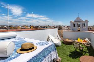 a hat sitting on a table on a roof at CH Apartments Boutique in Seville