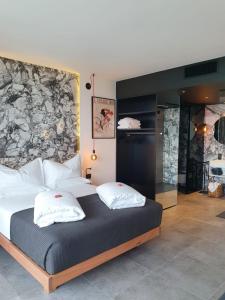 a bedroom with a large bed with two pillows at Visioni Lake View Boutique Rooms & Breakfast - Adults Friendly in Riva del Garda