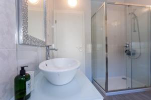 a white bathroom with a sink and a shower at Melki for 12 people with private pool in Klis