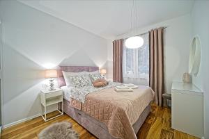 a small bedroom with a bed and a window at Blue apartment in Ston