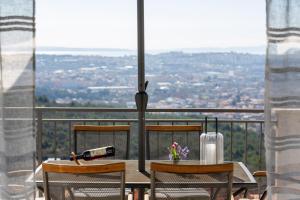a table and chairs with a view of a city at Melki for 12 people with private pool in Klis