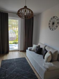 a living room with a couch and a large window at GOCZÓWKA in Siemiany