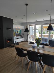 a living room with a table and chairs and a fireplace at GOCZÓWKA in Siemiany