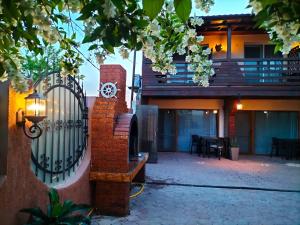 a gate in front of a house with a clock on it at Casa Cristina Corbu in Corbu