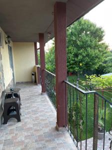 a balcony of a house with a table and chairs at Vila Vlad in 2 Mai