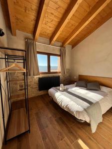a bedroom with a large bed in a room with wooden ceilings at Cal Bertran in Segura +47 photos