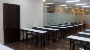 a row of tables and chairs in a room at Hotel Candamo in Lima